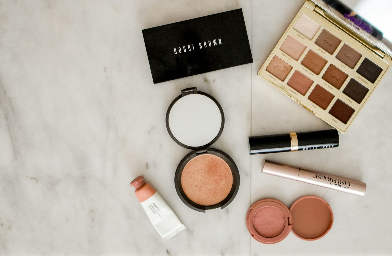 A compact makeup organizer being packed into a travel suitcase