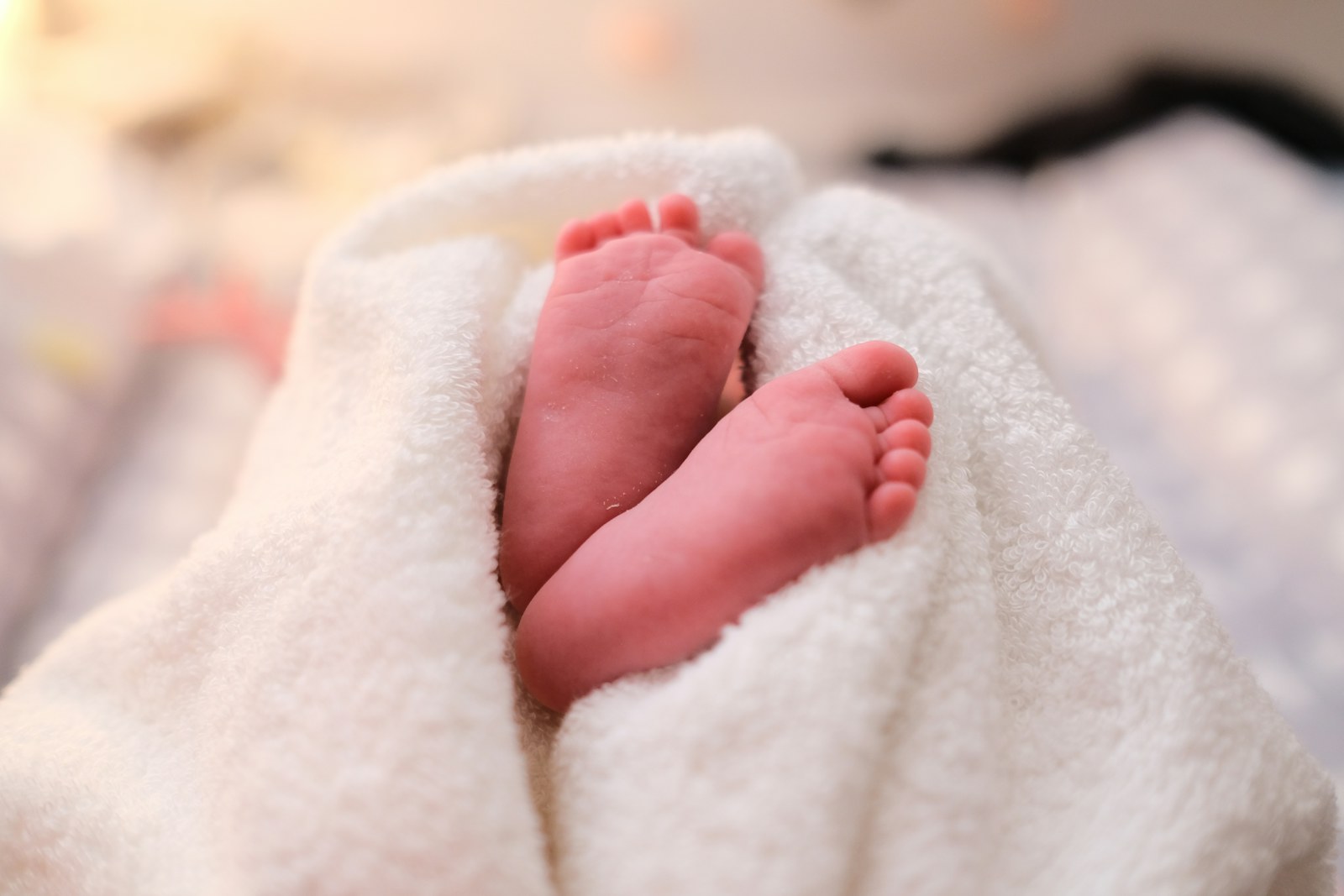 A folded textured blanket on a sofa in a comfortable living room